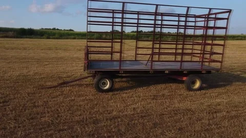A Front to Rear View of a Hay Wagon Parked in a Field Stock Footage 167094631