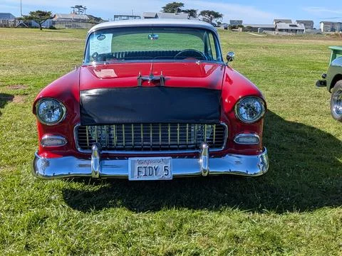 Front of a red 1935 Chevy Bel Air with black leather hood bra Stock Photos