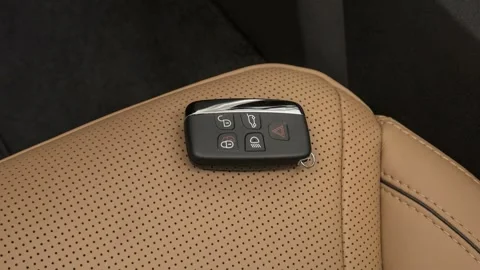 Front seat in car interior with keys close up  2017 Land Rover Discovery HSE Stock Footage 159942963