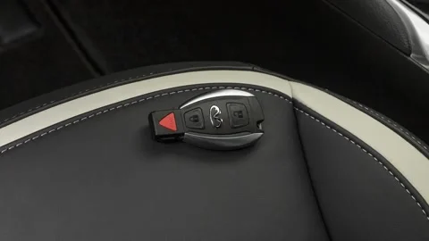 Front seat in car interior with keys close up  2018 Infiniti QX30 Sport Stock Footage 159953061