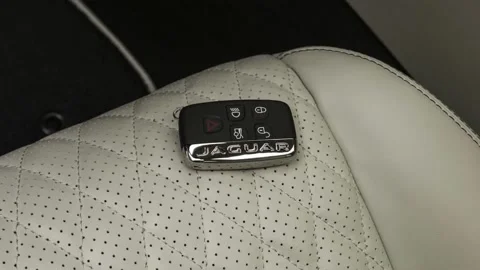 Front seat in car interior with keys close up  2018 Jaguar XJL Portfolio Stock Footage 160008348