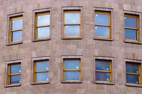 Front shoot of red stone covered new office building with wooden frame window Foto stock