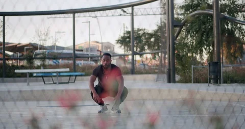 Front shoot through metal net of motivated powerful man doing intense training Stock Footage 123664973