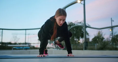 Front shot of diligent beautiful Caucasian female active workout on sport mat Stock Footage 123664254