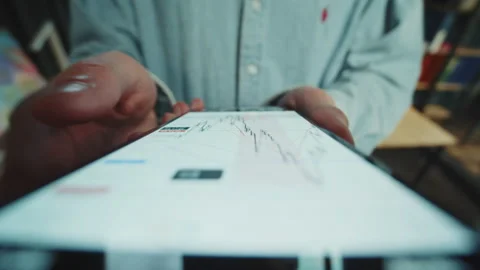 Front shot hands with a mobile phone, checking the market. Scrolling market Stock Footage 238743706