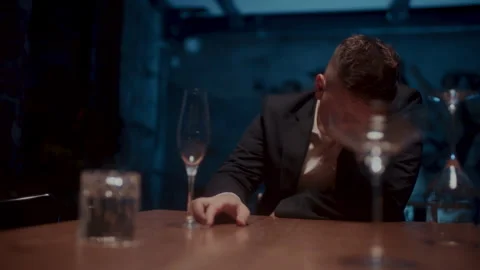 Front shot of A man sitting alone at the table and drinking Video stock 258333067