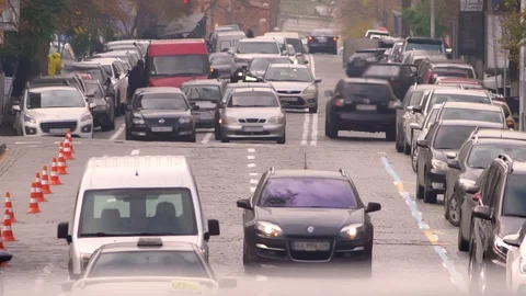 Front shot of vehicles slowly riding in traffic jam on city road. Video stock 101247768