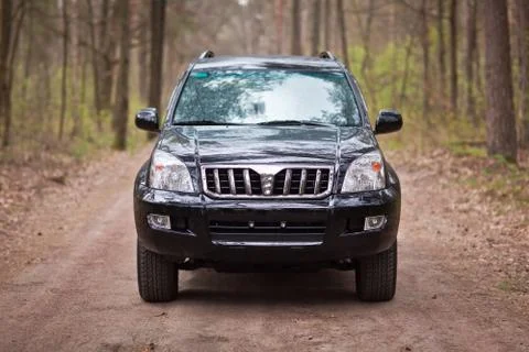 Front side of the black SUV in forest Stock Photos
