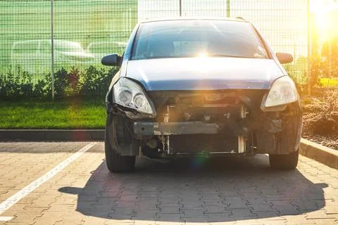 Front side of crashed car after accident on the road. Wrecked car on the park Stock Photos
