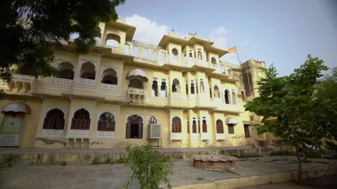 Front Side of a Historic Yellow Castle with Arched Windows and Balconies in Stock Footage 310936460