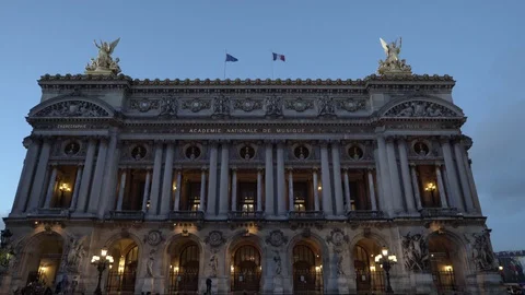 Front side of the Opera of Paris illuminated during the sunset of a clear sky. Stock Footage 93256563