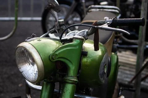 Front side perspective of green vintage motorcycle headlight fuel tank and .. Fotos de archivo