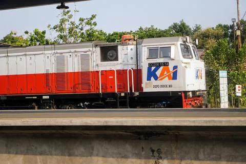 Front side of a red and white KAI train locomotive passing through Stock Photos
