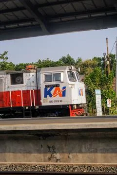Front side of a red and white KAI train locomotive passing through Stock Photos