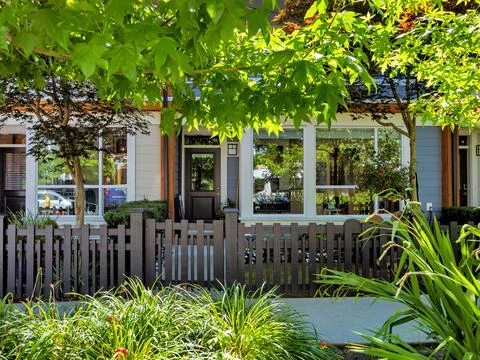 Front side of residential units with small yards and concrete walkway in front Stock Photos