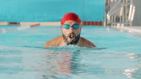 Front side shot of professional swimmer performing breaststroke during training Stock-Footage 120300981
