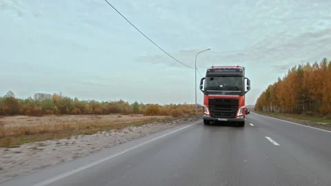 Front Side view of truck with cargo trailer driving alone on multilane road Stock Footage 195978145