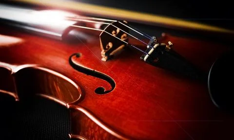 Front side of violin put on black canvas,Lens flare effecn,blurry light aroun Stock Photos