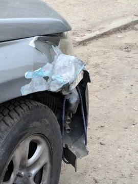 Front of silver car get damaged by crash accident on the road. The wing of a  스톡 사진