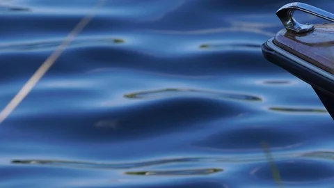 Front of a small boat bobs up and down on calm glassy river Stock Footage 106771713