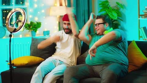 In front of the smartphone using a light ring recording a funny dance two Video stock 146472211