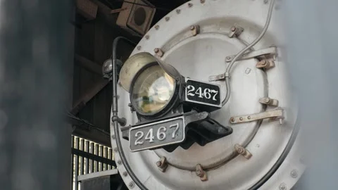 Front smokebox, headlight, and number 2467 plates of a steam train engine Vídeo Stock 344991995