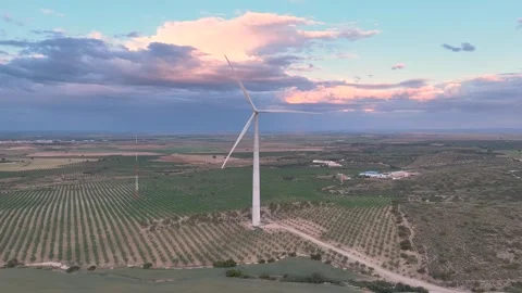 Front static aerial view of a wind turbine with its blades rotating Stock Footage 274528270