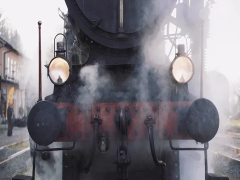 Front of a steam train on a railway with smoke - slow motion Stock Footage 106510797
