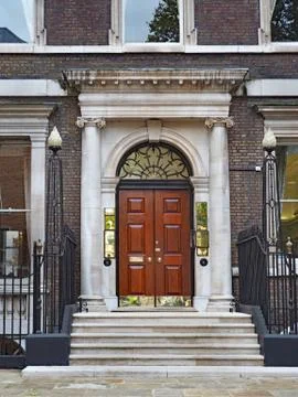 Front steps and door to old fashioned European office Stock Photos
