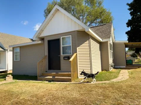 The front steps of a house with a dog Stock Photos