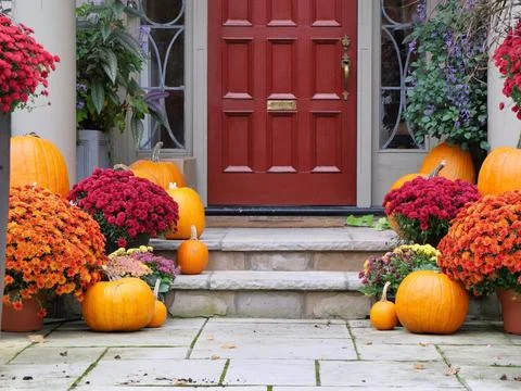 Front steps of house with fall decorations, flowers and pumpkins Stock Photos