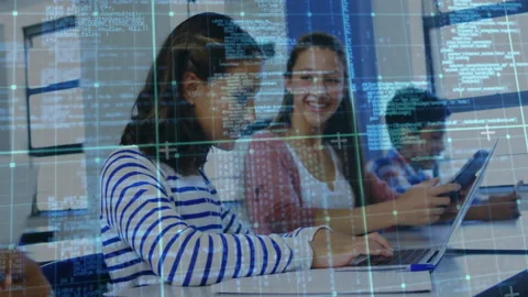Front student typing on laptop in classroom with partner pointing at code Stock Footage 312361397