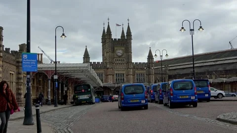 Front of Temple Meads Train Station with queuing blue taxis and bus at bus stop Stock Footage 272985684