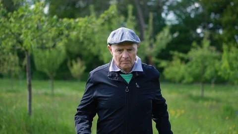 Front Tracking Shot of Senior Man Jogging in Nature Environment Slow Motion Stock Footage 113274708