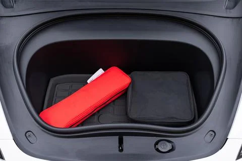 Front trunk or frunk under the hood lockable waterproof storage compartment of Stock Photos