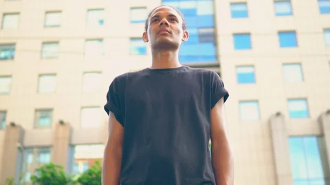 Front view african american man walks to the camera outdoors Stock Footage 119569108