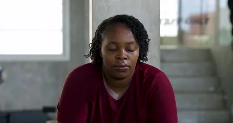 Front view of African American plus size woman sitting quietly after boxing Stock Footage 337809104