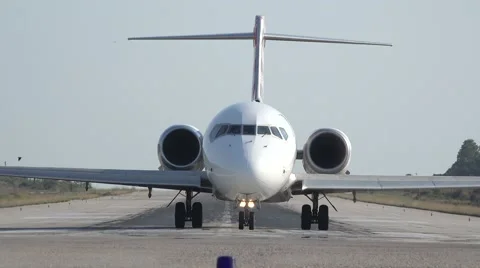 Front view of airplane coming closer on airport runway Video stock 64451335