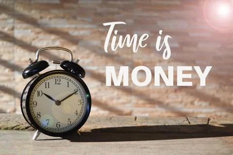 Front view of alarm clock on the table with text TIME IS MONEY Stock Photos