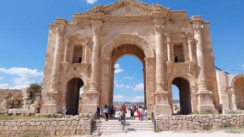 Front view of the ancient Arch of Hadrian in Jerash, Jordan, with tourists Stock Photos