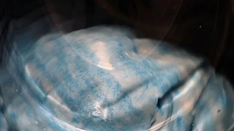 Front view and portion of the porthole of the washing machine during washing Stock Footage 70048714