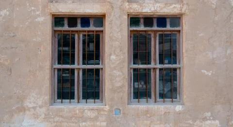 Front view of an Arabic old wall with traditional wooden windows and door in  Photos