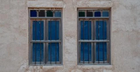 Front view of an Arabic old wall with traditional wooden windows and door in  Stock Photos