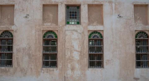 Front view of an Arabic old wall with traditional wooden windows and door in  Stock-Fotos