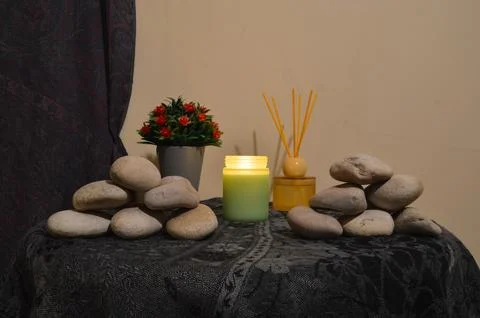 Front View of Aromatic Candle and Zen Stones for Spa Stock Photos