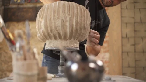 A front view of an artist performing unique ceramic pot making. Creating Stock Footage 113081370