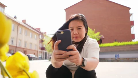 Front view of Asian black straight hair woman sitting and taking a photo Stock Footage 169856630