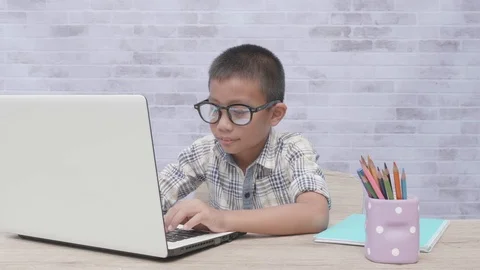 Front view of asian boy using laptop while homework. Stock Footage 117290292