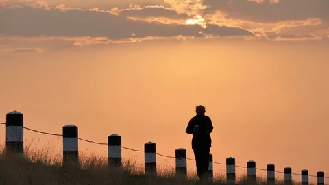 Front view Asian elderly exercise. Senior man running on road In the morning Stock Footage 125477249