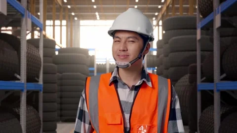 Front View of Asian Male Engineer Waving Hand Saying Bye While Walking at Tire Stock Footage 341784204